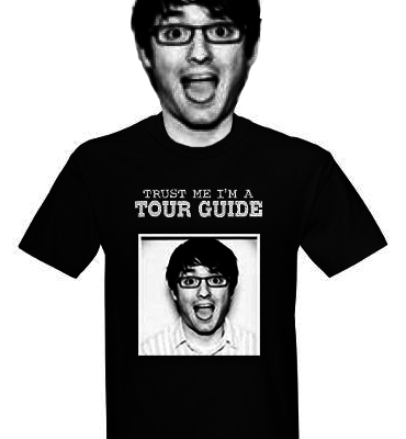 a guy in a tour guide t shirt with his mouth open